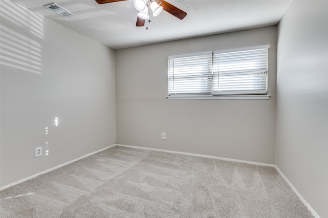 spare room featuring ceiling fan and light colored carpet