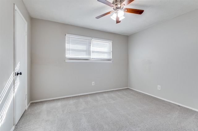 unfurnished room featuring ceiling fan and light carpet