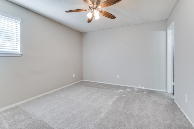 unfurnished room with ceiling fan and light colored carpet