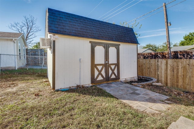 view of outbuilding featuring a lawn