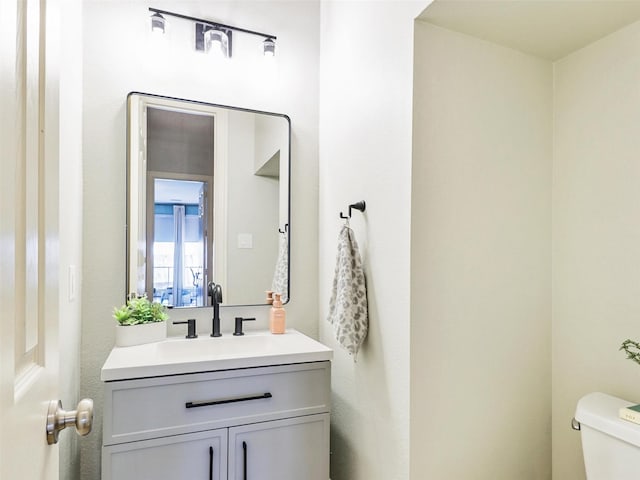 bathroom featuring toilet and vanity