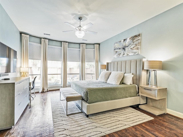 bedroom with ceiling fan and dark hardwood / wood-style flooring