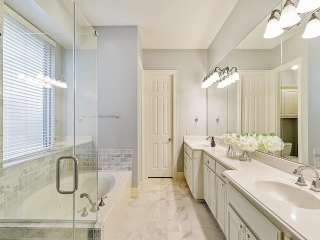 bathroom featuring toilet, vanity, and a tub