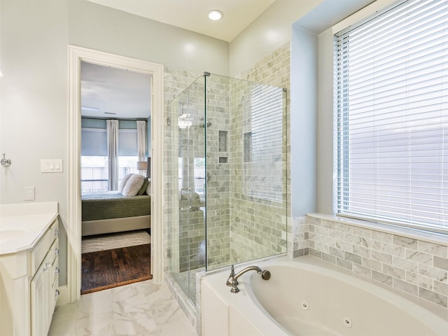 bathroom featuring separate shower and tub and vanity