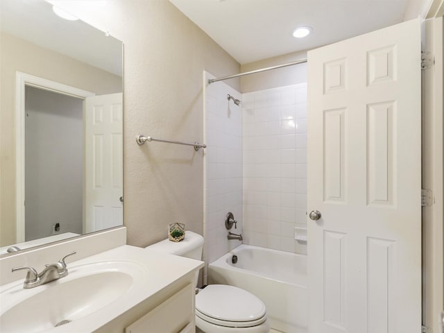 full bathroom with toilet, tiled shower / bath combo, and vanity