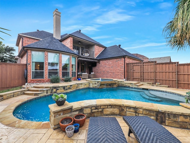 view of swimming pool featuring an in ground hot tub