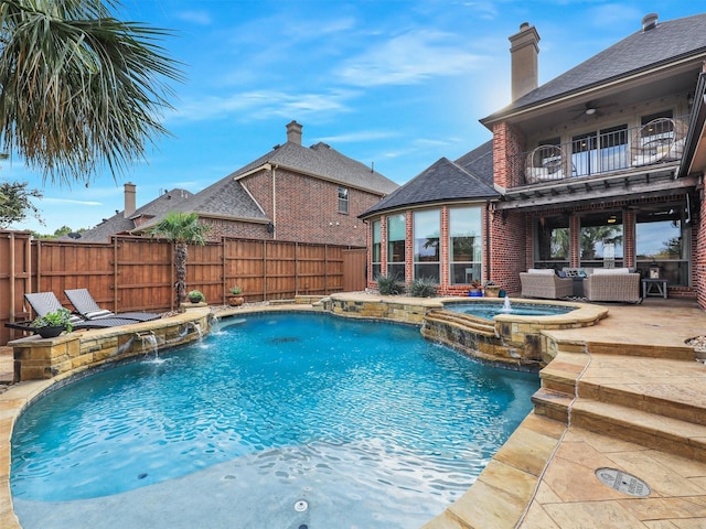 view of pool with ceiling fan, outdoor lounge area, pool water feature, an in ground hot tub, and a patio