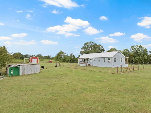 view of yard with an outbuilding and a rural view