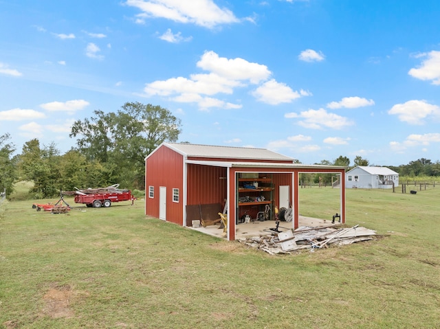 view of outbuilding featuring a yard