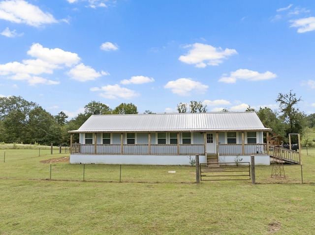 view of front of property featuring metal roof, a porch, a front lawn, and board and batten siding