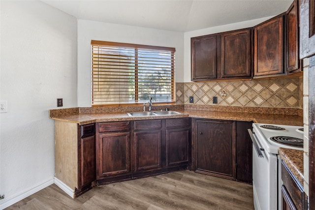 kitchen with sink, white range with electric stovetop, light hardwood / wood-style flooring, and decorative backsplash