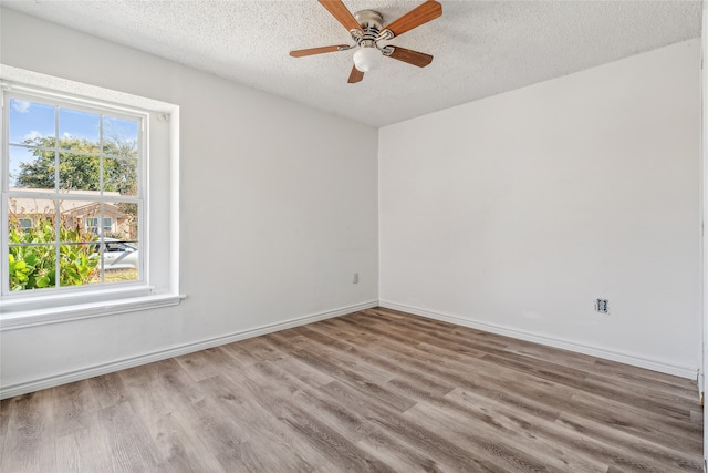 unfurnished room featuring light hardwood / wood-style floors, a textured ceiling, and ceiling fan