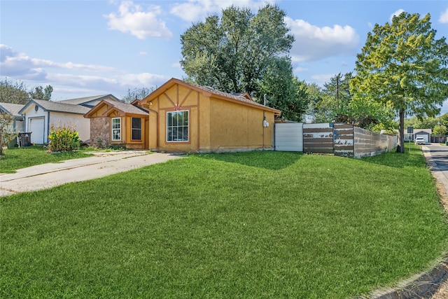 view of front of property with a front yard and a garage