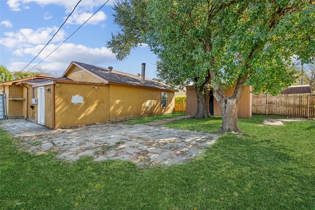 back of property with a patio and a lawn