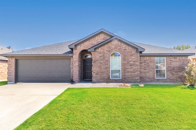 view of front of house with a garage and a front lawn