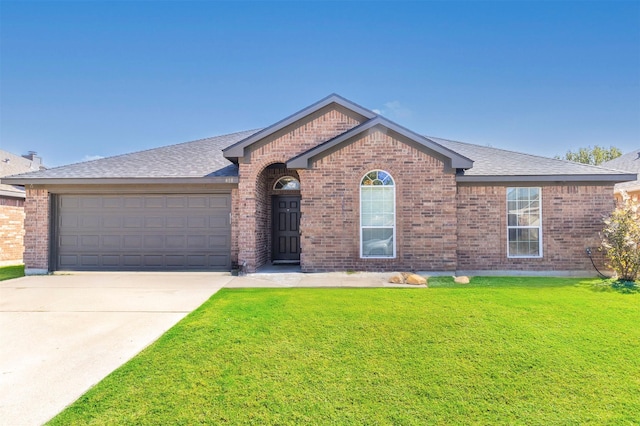 view of front of house with a garage and a front lawn