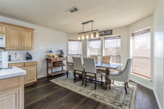 418 Mcmurtry Dr, Arlington, TX 76002 - dining space featuring dark wood-type flooring, a textured ceiling, and baseboards