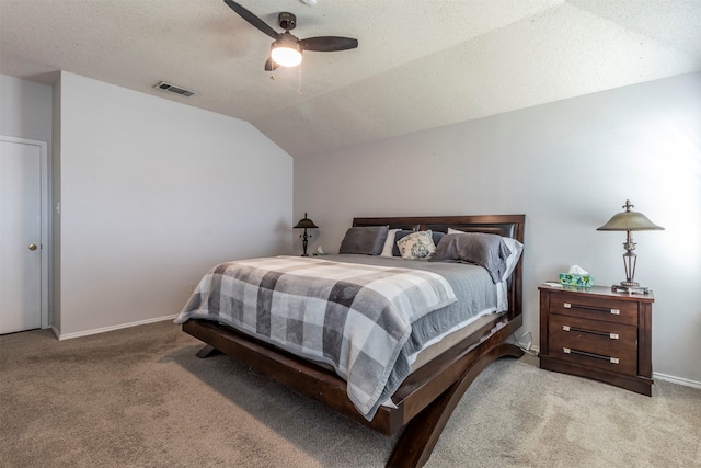 bedroom featuring ceiling fan, vaulted ceiling, a textured ceiling, and carpet