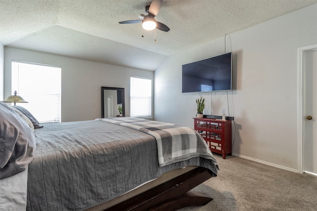 carpeted bedroom featuring ceiling fan, lofted ceiling, and a textured ceiling