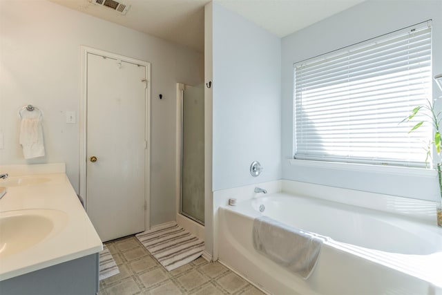 bathroom with shower with separate bathtub and vanity