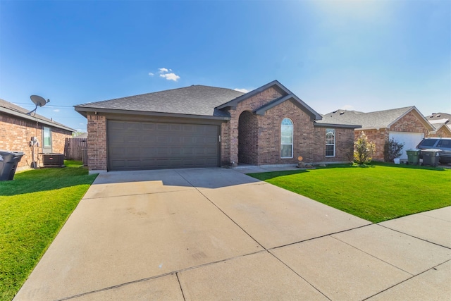 single story home with central air condition unit, a front yard, and a garage