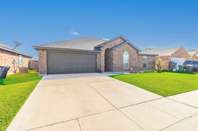 single story home with a garage, a front lawn, and central air condition unit