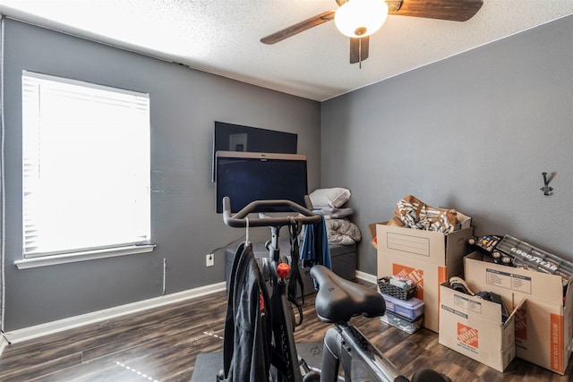 interior space featuring a textured ceiling, dark hardwood / wood-style floors, and ceiling fan