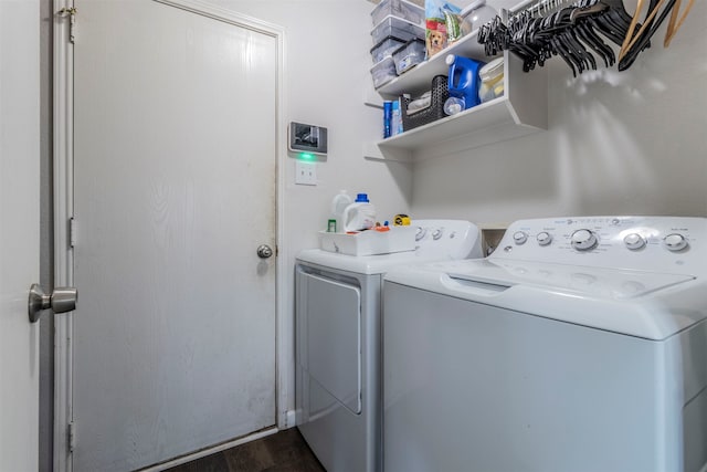 laundry area with dark hardwood / wood-style flooring and independent washer and dryer