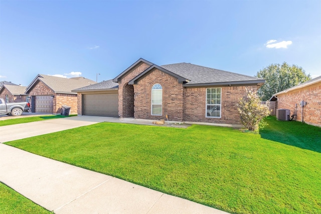 ranch-style house featuring a garage, central AC, and a front yard