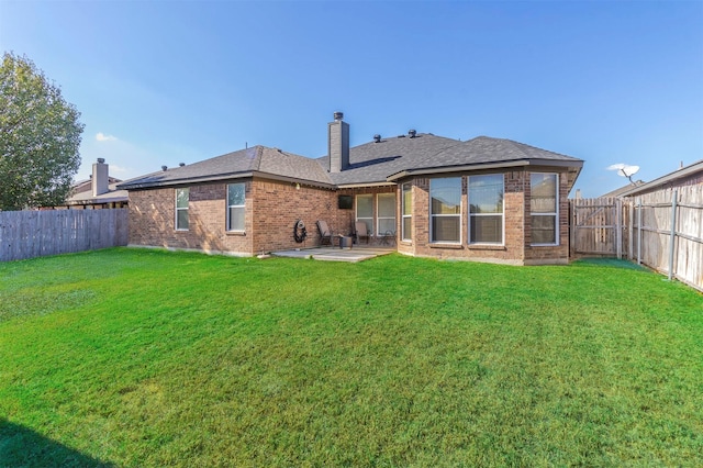 back of property featuring a yard and a patio