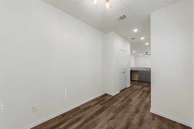 hallway with dark hardwood / wood-style floors