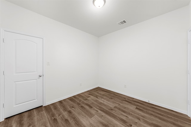 spare room featuring wood-type flooring