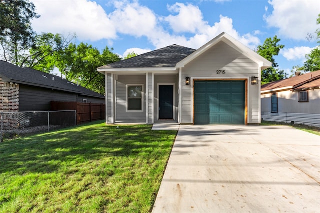 view of front of property with a garage and a front lawn