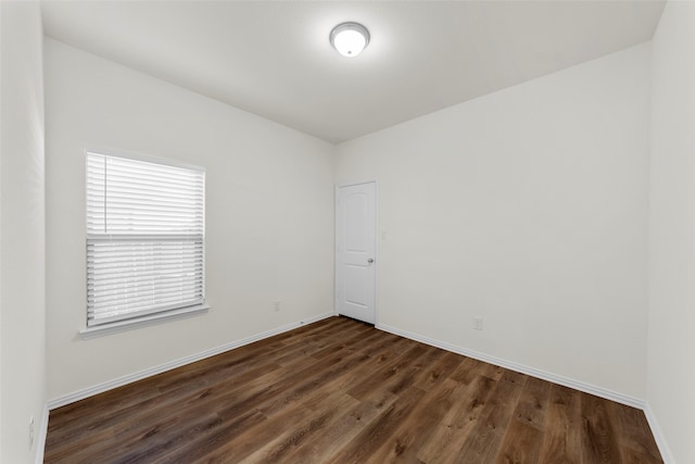 unfurnished room with dark hardwood / wood-style floors