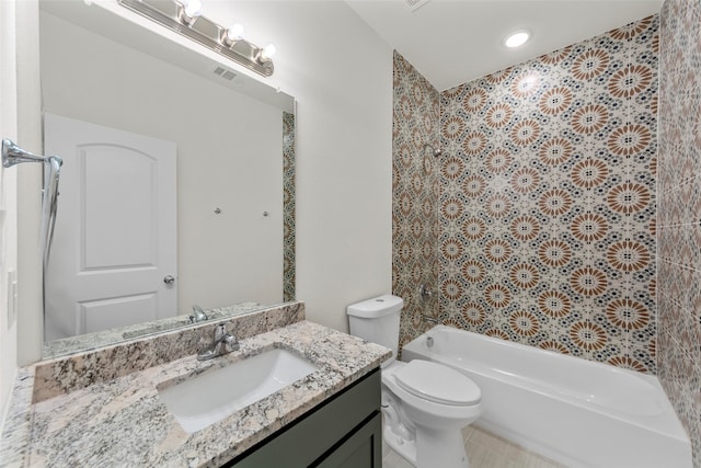 full bathroom with toilet, vanity,  shower combination, and tile walls