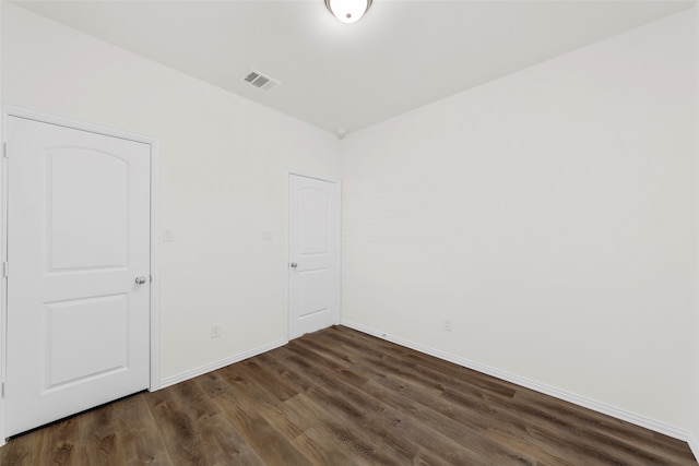 unfurnished room featuring dark hardwood / wood-style floors