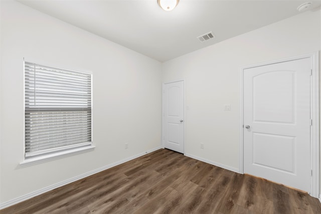 unfurnished room with dark hardwood / wood-style floors