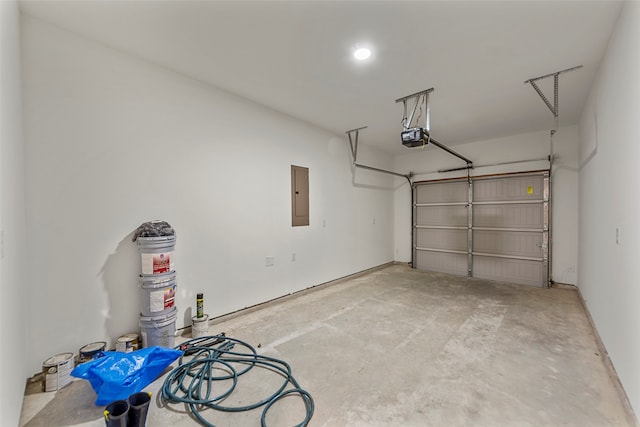 garage with electric panel and a garage door opener