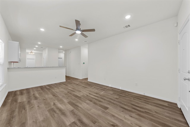 unfurnished living room with ceiling fan and hardwood / wood-style flooring