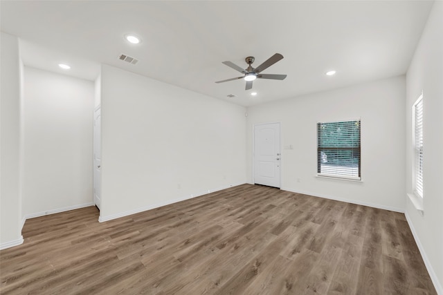 spare room featuring hardwood / wood-style floors and ceiling fan