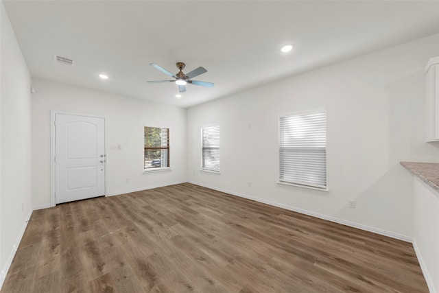 interior space with hardwood / wood-style floors and ceiling fan