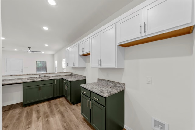 kitchen with light hardwood / wood-style flooring, green cabinets, sink, white cabinetry, and ceiling fan