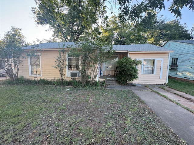 view of front of property with cooling unit and a front lawn