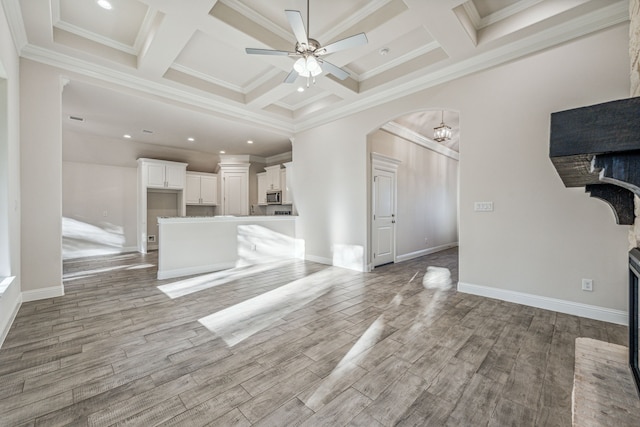 unfurnished living room featuring crown molding, light hardwood / wood-style floors, and coffered ceiling