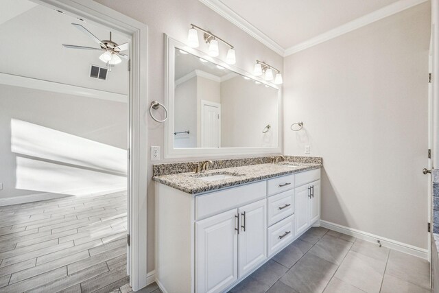 bathroom featuring tile patterned flooring, ceiling fan, ornamental molding, and vanity