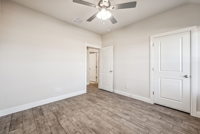 unfurnished bedroom with light hardwood / wood-style flooring, ceiling fan, and lofted ceiling