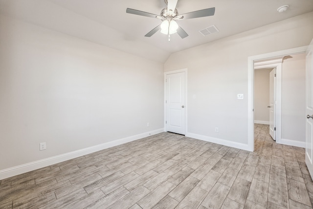 spare room featuring ceiling fan, light hardwood / wood-style floors, and lofted ceiling