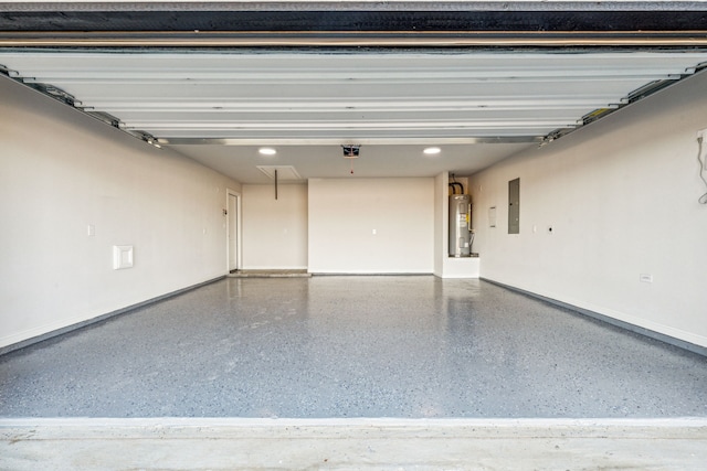 garage featuring electric panel and water heater