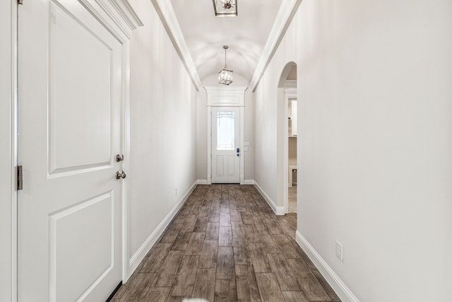 entryway featuring hardwood / wood-style floors, lofted ceiling, and crown molding