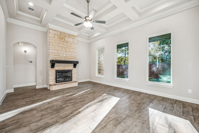 unfurnished living room with beam ceiling, ornamental molding, coffered ceiling, and hardwood / wood-style flooring